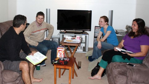 Young adults group doing a bible study.
